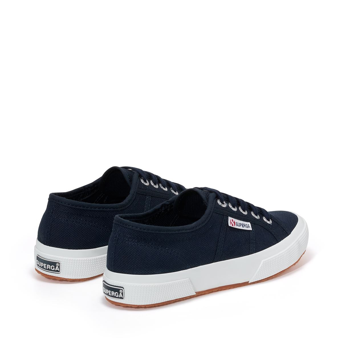 navy blue canvas sneakers with white rubber outer sole slight back view