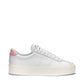 White leather shoe with pink detail and cream platform rubber outer sole side view