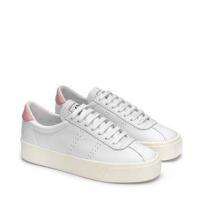 White leather shoes with pink detail and cream platform rubber outer sole slight top view