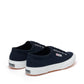 navy blue canvas sneakers with white rubber outer sole slight back view
