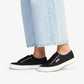 pair of navy canvas Superga shoes modelled with light blue denim jeans
