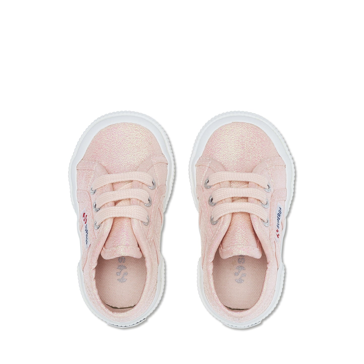 baby Superga shoes in pastel peach colour and white rubber soles top view